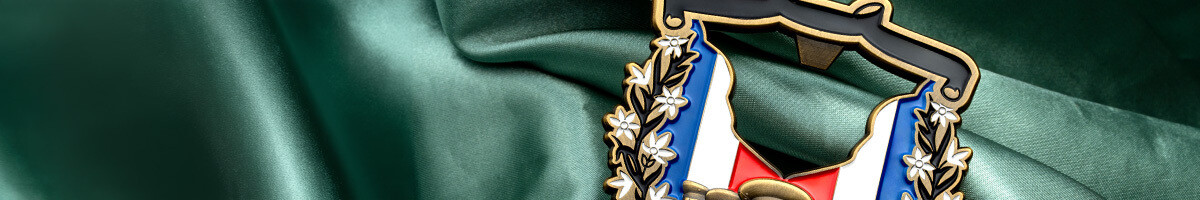 Close crop of the Marine Security Guard bottle opener coin's laurel wreath and tricolor ribbon
