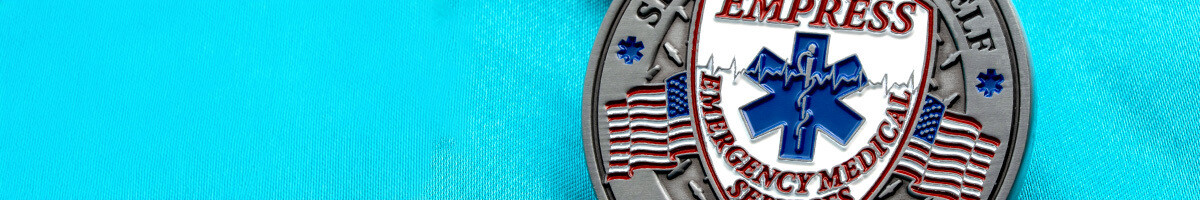 Empress Emergency Medical Services challenge coin with a Star of Life shield, EKG line, and American flags