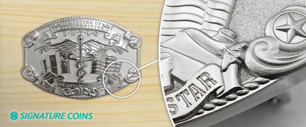 Close-up of the 3D relief detail on an antique silver Navy Medicine belt buckle