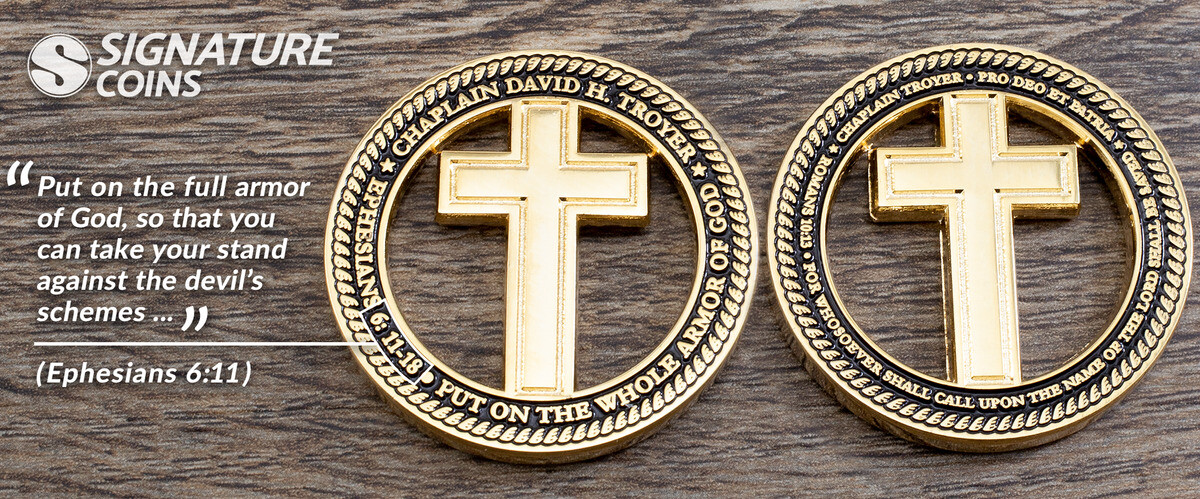 Two gold chaplain coins with crosses cut through the center, engraved with Pro Deo Et Patria and the Ephesians 6:11 full armor of God verse