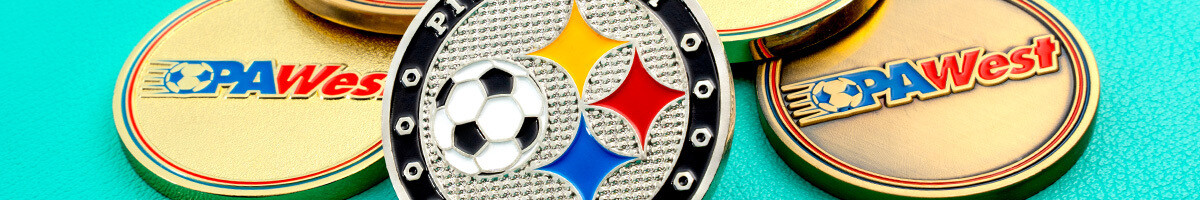 Nickel soccer referee coin with a soccer ball and city colors resting on gold league coins