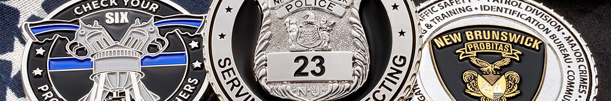 Three police challenge coins including a Check Your Six thin blue line design and a New Brunswick Police badge coin