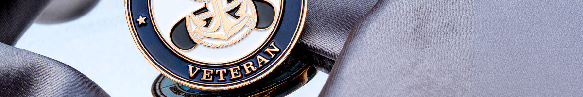 Navy blue and gold veteran challenge coin with a fouled anchor emblem